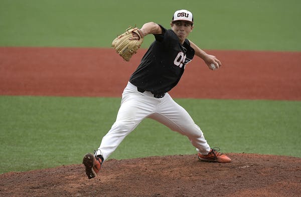 Oregon State's Luke Heimlich throws to a Minnesota batter in the opening game of an NCAA college baseball tournament super regional in Corvallis, Ore.