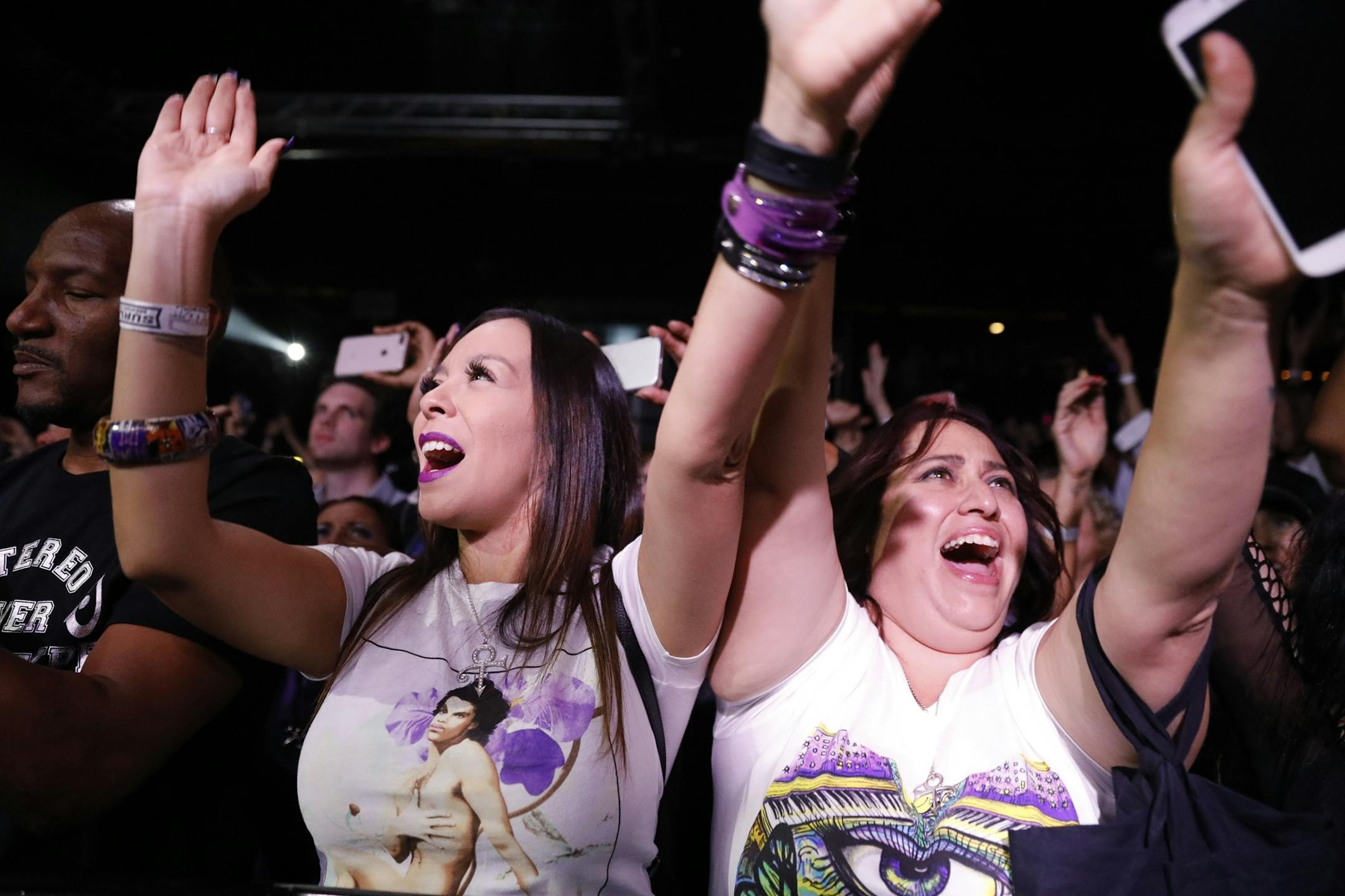 Fans sing along during the New Power Generation show.