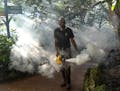 Fran Middlebrooks, a grounds keeper at Pinecrest Gardens, former home of the historic Parrot Jungle, uses a blower to spray pesticide to kill mosquito