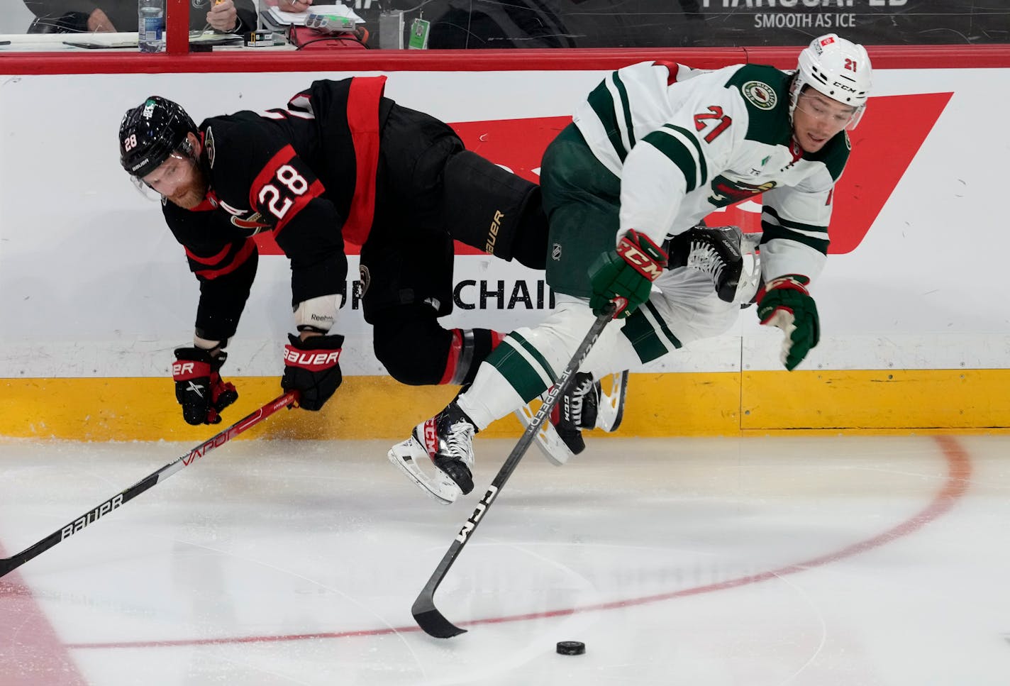 Wild right wing Brandon Duhaime reached for the puck as he collided with Ottawa right wing Claude Giroux on Thursday in Minnesota's 4-2 victory.