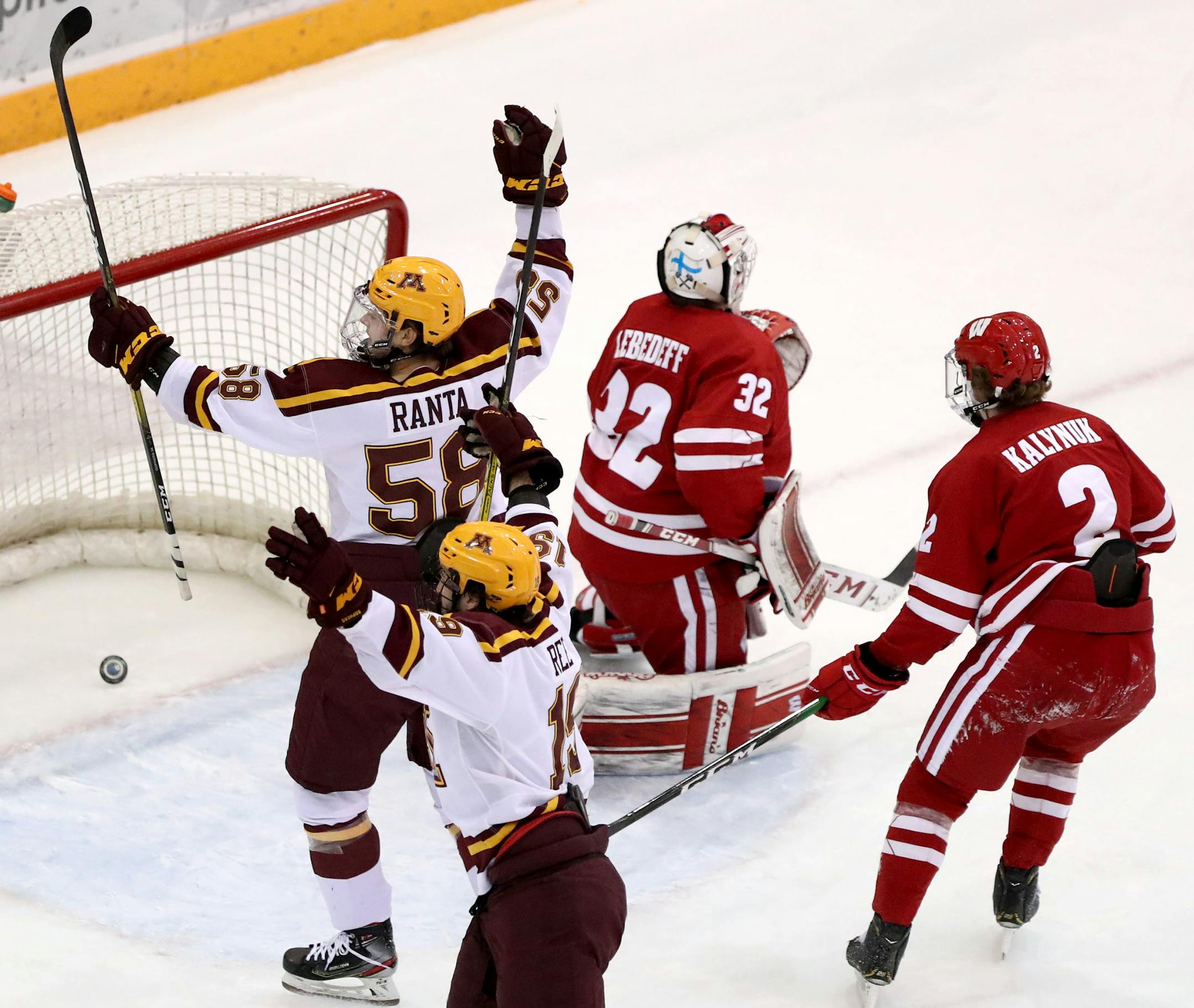 The Gophers' Scott Reedy (19) scores past Wisconsin's goalie Daniel Lebedeff during the first period.