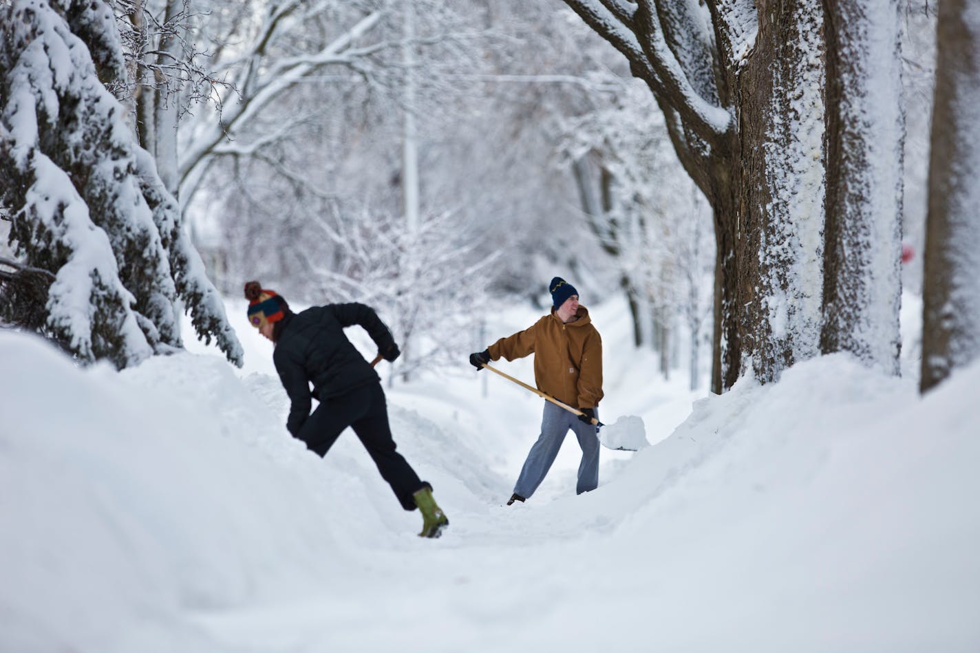 Neighbors Andrea Page and Peter Jorgensen were two of several neighbors clearing the sidewalk of their Minneapolis neighborhood which had still yet to be plowed the morning after 10.5 inches of snow fell in the Minneapolis, Minn., on Friday, February 22, 2014. ] (RENEE JONES SCHNEIDER reneejones@startribune.com) ORG XMIT: MIN1402211137444154