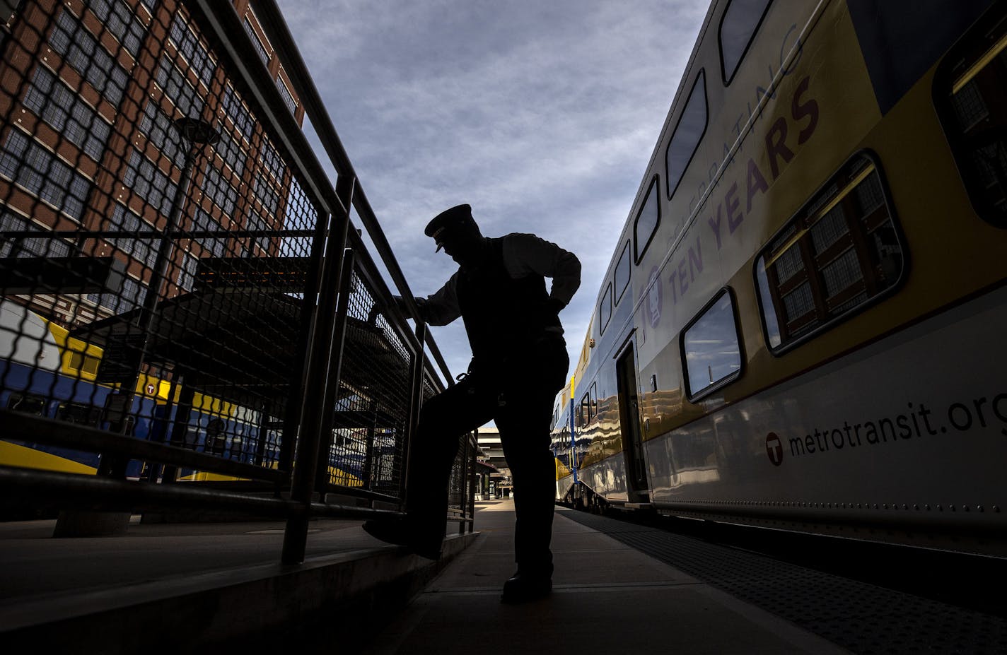 Northstar Commuter Rail conductor Vincent Roberts adjusted his radio while standing outside of the last train out of Minneapolis on Monday, Aug. 10.