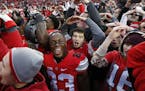 FILE - In this Saturday, Nov. 26, 2016, file photo, Ohio State players and fans celebrate their win over Michigan in an NCAA college football game in 