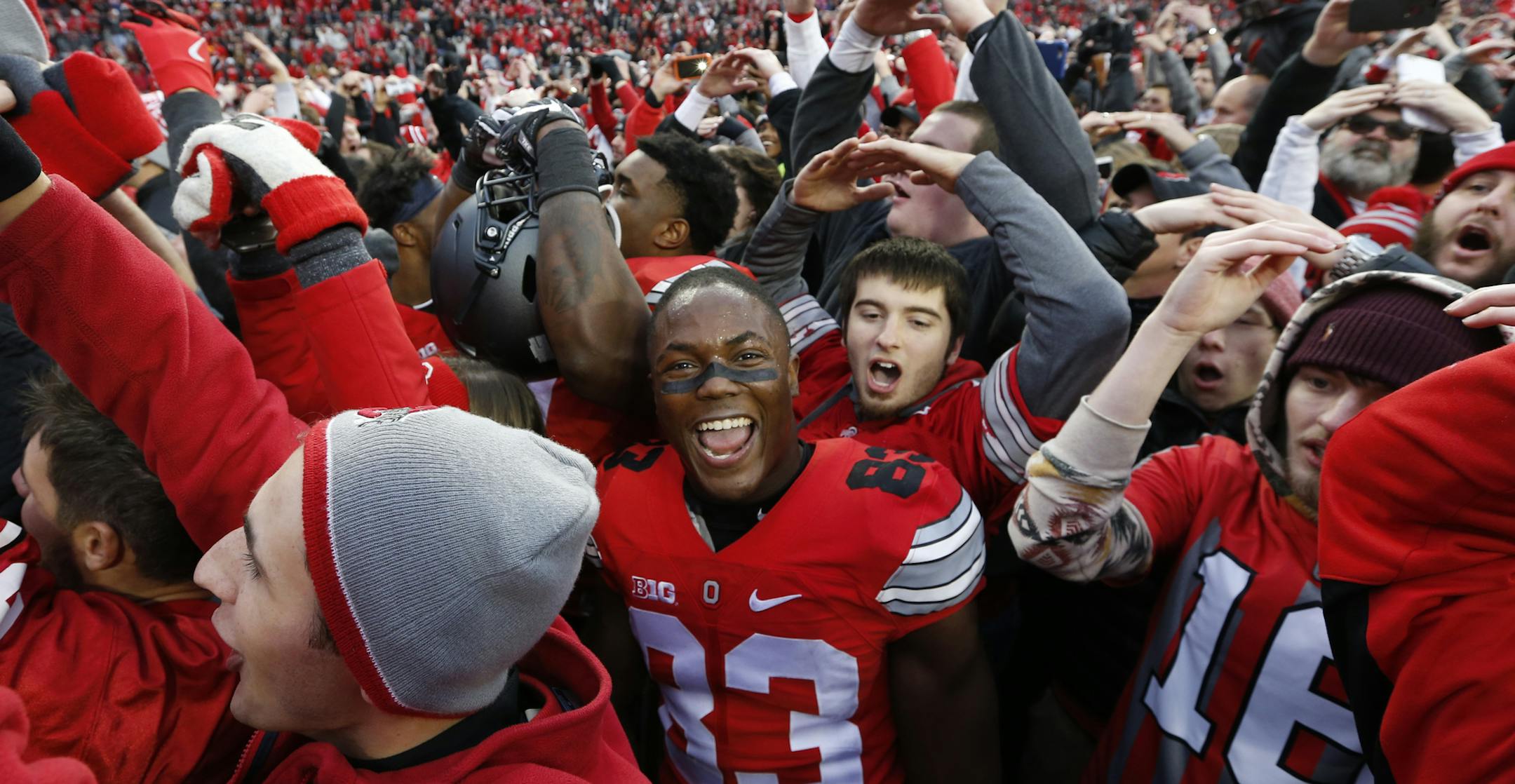 FILE - In this Saturday, Nov. 26, 2016, file photo, Ohio State players and fans celebrate their win over Michigan in an NCAA college football game in Columbus, Ohio. Ohio State beat Michigan 30-27 in double overtime. Geologists measuring vibrations caused by boisterous Ohio State football fans say the Buckeyes' game-winning touchdown in double overtime against rival Michigan had Ohio Stadium rocking more than any other time this season. (AP Photo/Jay LaPrete, File)