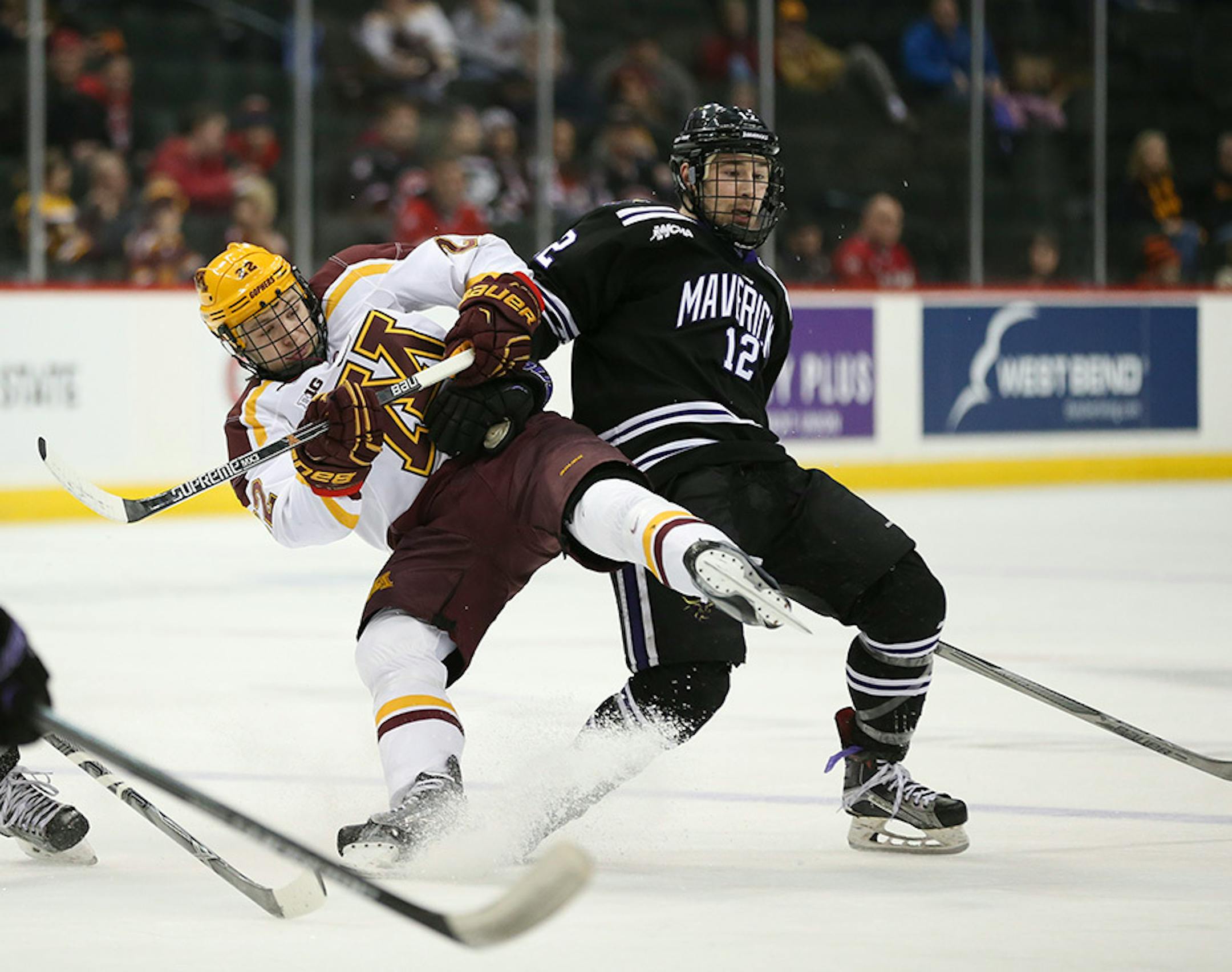 Gophers forward Tyler Sheehy (22) was taken out of a play by Mavericks forward Max Coatta (12) in the third period Sunday afternoon.