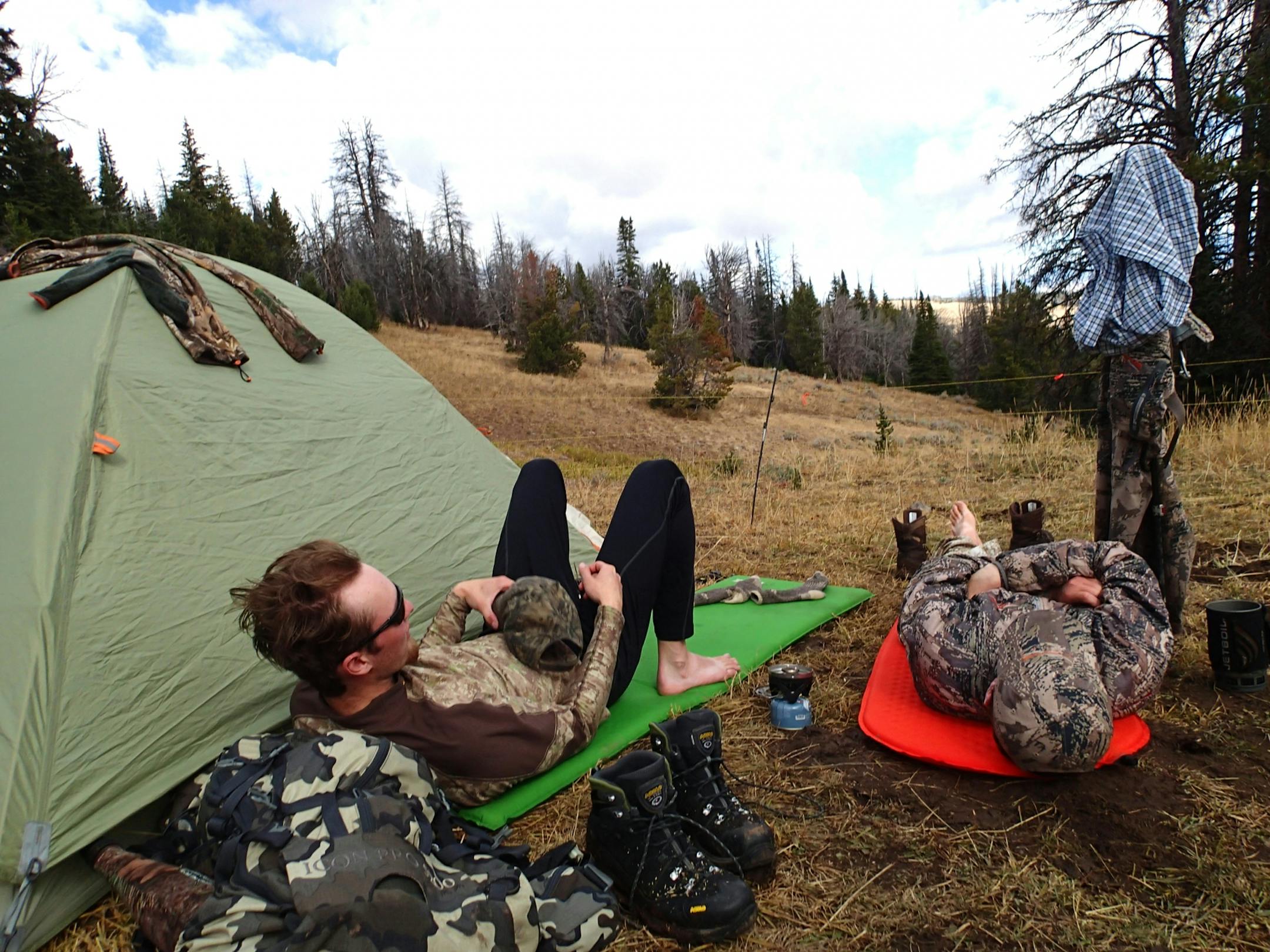 Taking a mid-day break at the tent camp they shared with Dennis Anderson, Alec Underwood, left, and Trevor Anderson rest up in midday after rising in the pre-dawn dark and hiking into the surrounding mountains with their bows, looking for elk. Morning temperatures at their camp, located at about 9,000 feet, were in the mid-20s.