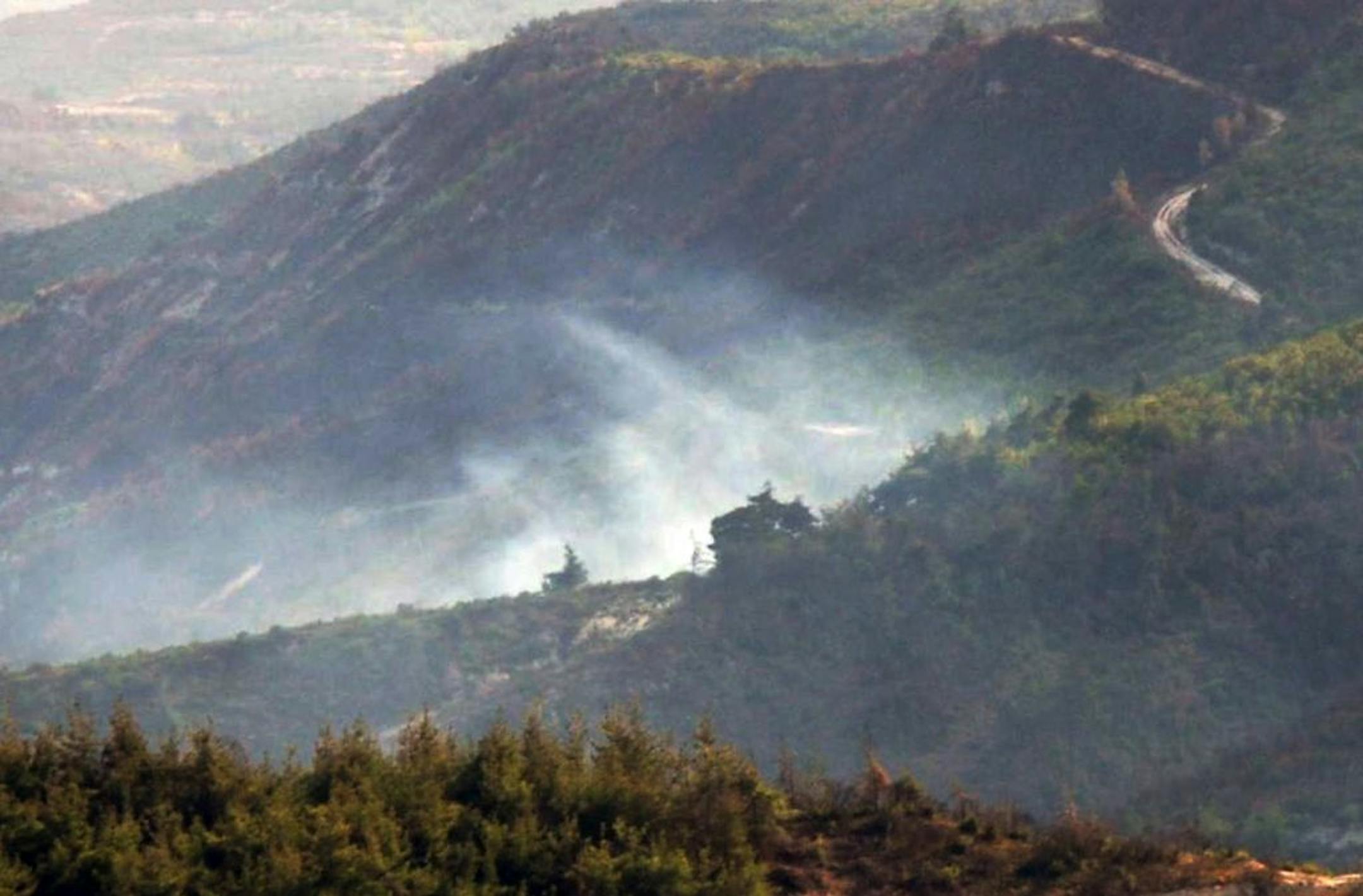 Smoke rises from the Syrian side of the border after a Turkish air force jet downed a Syrian military helicopter at the Turkey-Syria border near Hatay province, Turkey, Monday, Sept. 16, 2013. Turkey�s deputy prime minister, Bulent Arinc, says a Turkish jet has shot down a Syrian military helicopter after it entered Turkish airspace. Arinc told reporters in Ankara that the pilots of the helicopter were warned repeatedly on Monday after they had strayed 2 kilometers (more than 1 mile) into Turkis