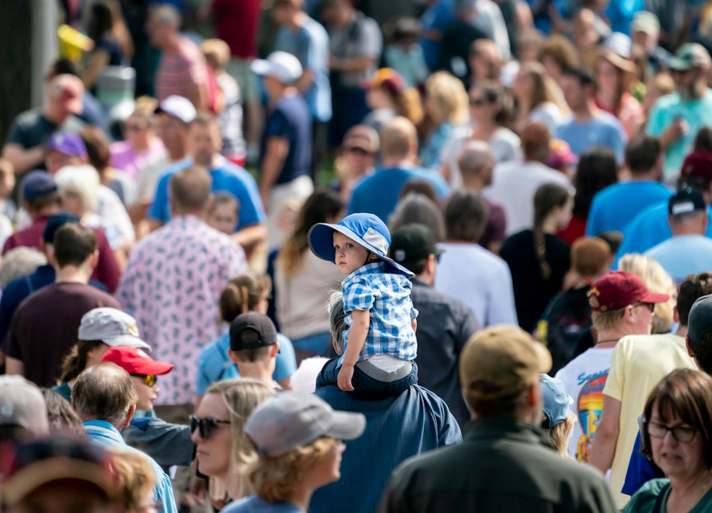 Eddie Hoeschen, 2, rode on his grandpa Kevin Hoeschen's, of Duluth, shoulders as they walked through a thick crowd at the 2019 Minnesota State Fair.