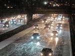 Traffic travels west near the Interstate 94 and Interstate 35W interchange as snow falls on Nov. 14 in Minneapolis.