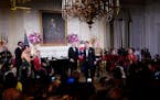 President Joe Biden listens as South Korea’s President Yoon Suk Yeol sings the song “American Pie” in the State Dining Room of the White House o