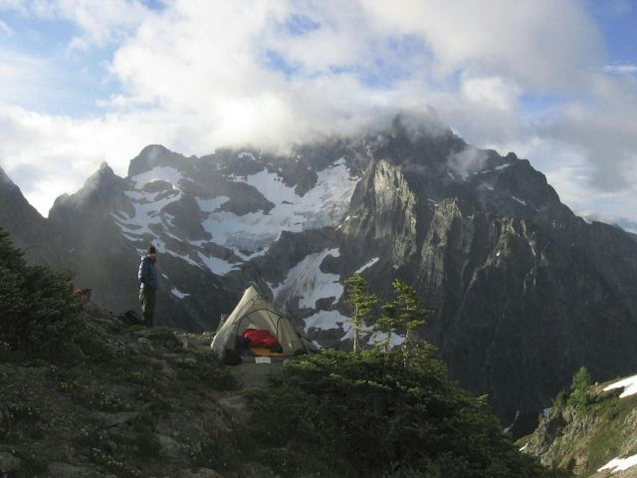 The sun breaks through early morning clouds near Easy Pass and Fisher Basin. Download: 20090813182512.jpg