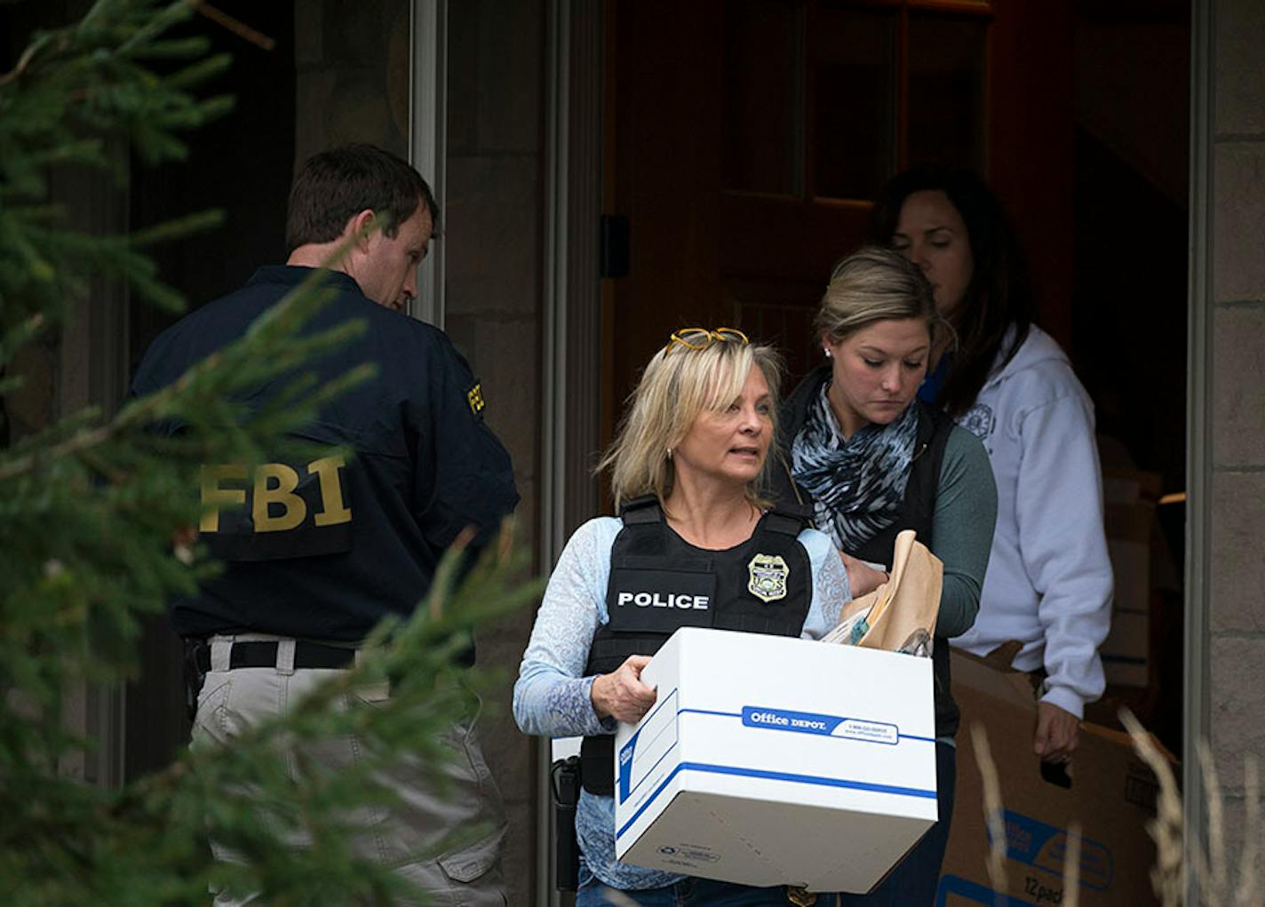 Law enforcement left the home of former Starkey President Jerry Ruzicka carrying evidence including a computer and boxes of documents Wednesday afternoon.