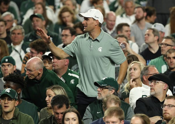 Michigan State football alum Kirk Cousins waved during a game between Michigan State and Texas Tech during the first half.