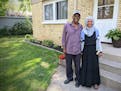 St. Cloud residents Youssouf "Joe" Omar and Hamdia Mohamed stand by a duplex they own as part of their business, Victory Plus Housing, which provides 