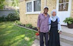 St. Cloud residents Youssouf "Joe" Omar and Hamdia Mohamed stand by a duplex they own as part of their business, Victory Plus Housing, which provides 