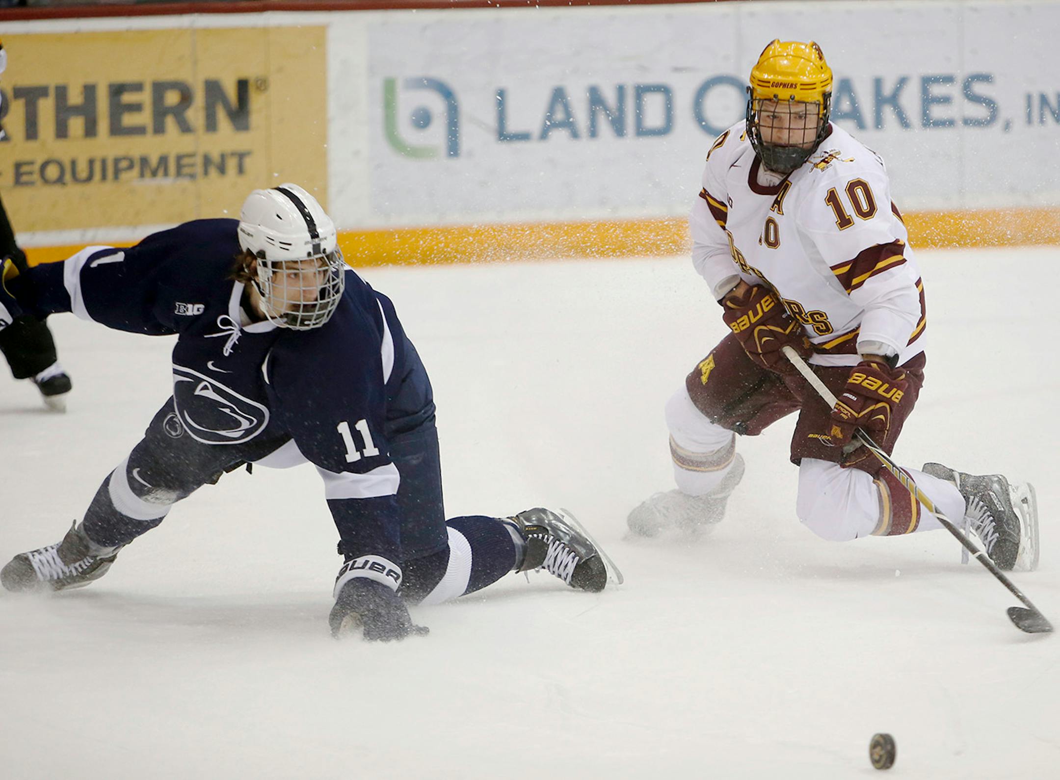 The University of Minnesota's Ben Marshall (10) and Penn State's David Glen (11) battle for a loose puck during the first period at Mariucci Arena Friday, March13, 2015, in Minneapolis, MN.