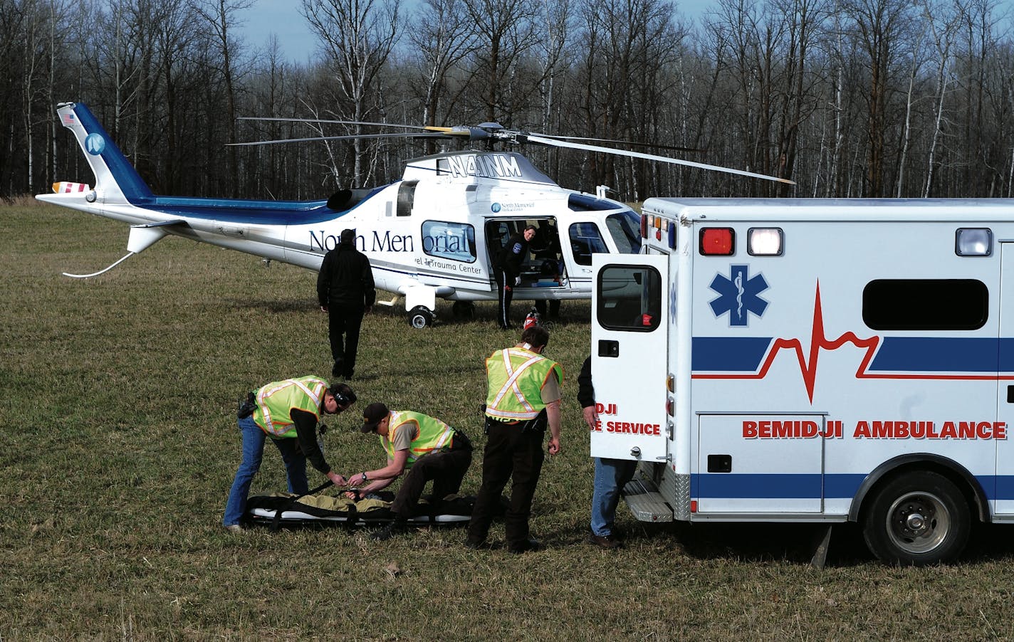 > Monte Draper | Bemidji Pioneer > > > Beltrami and Clearwater County sheriff�s > officials pack up an empty gurney Friday afternoon as a helicopter crew from > North Memorial responded after a sailboat capsized on Clearwater Lake, > northwest of Debs. A father and three children were in the boat when it > capsized.