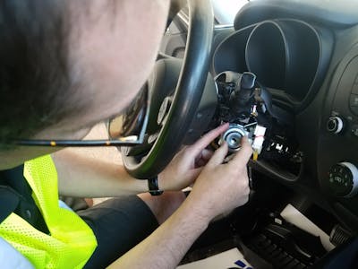 Kia technician Yurii Gul installs an ignition sleeve protector in a vehicle Friday during an anti-theft clinic at the Mall of America.