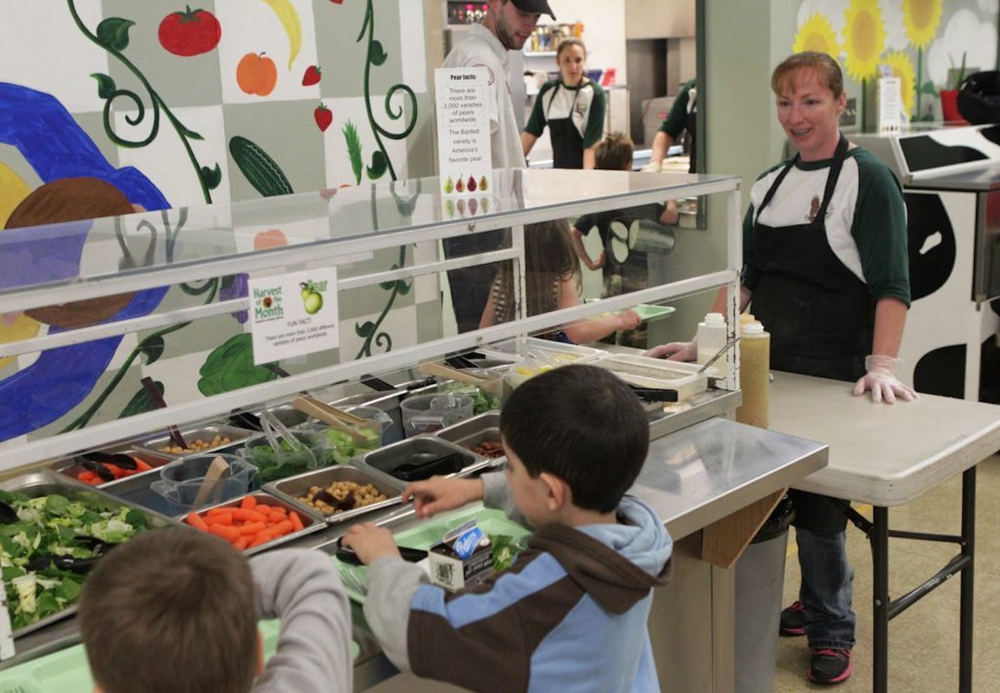 Kim Morris, head cook at Bella Vista School, watches as students at the salad bar on Friday, Jan. 10, 2014, at the school in Bella Vista, Calif. Morris makes much of the students' meals from scratch.