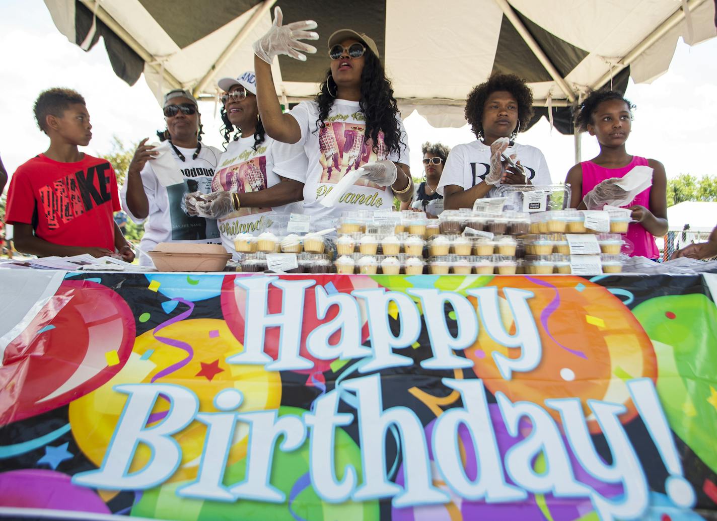 Allysza Castile, center, called to passersby with her mother, Valerie Castile, white hat, as they passed out cupcakes with family and friends at the Rondo Days festival to celebrate Philando's 33rd birthday. ] Isaac Hale &#xef; isaac.hale@startribune.com The annual Rondo Days Festival kicked off with a parade in St. Paul on Saturday, July 16, 2016. The festival remembers the African-American community of Rondo, which was destroyed by I-94's construction in the 1960&#xed;s. The festivities also s