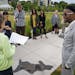 Artist Seitu Jones, right, joins a tour group to talk about "Harriet Robinson Scott" from the series "Shadows at the Crossroads" during the public unv