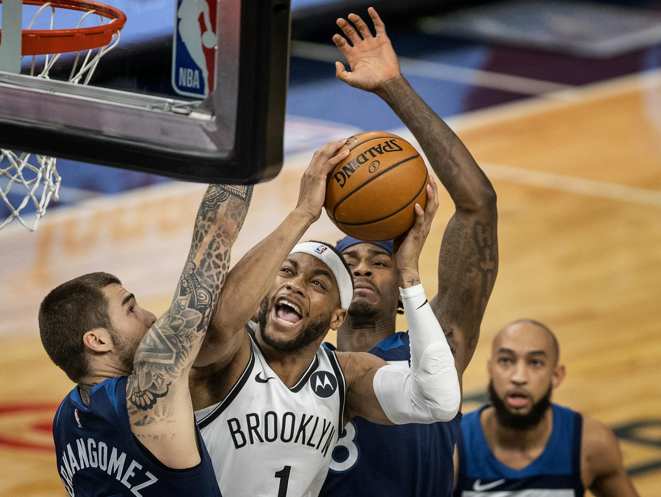 Brooklyn Nets forward Bruce Brown (1) drove to the basket  on Minnesota Timberwolves forward Juancho Hernangomez (41) and forward Jarred Vanderbilt (8) at Target Center on April 13, 2021 in Minneapolis.