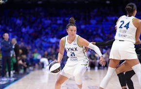 Lynx star Kayla McBride dribbles around a screen set by Napheesa Collier against Dallas on Sunday in Arlington, Texas.