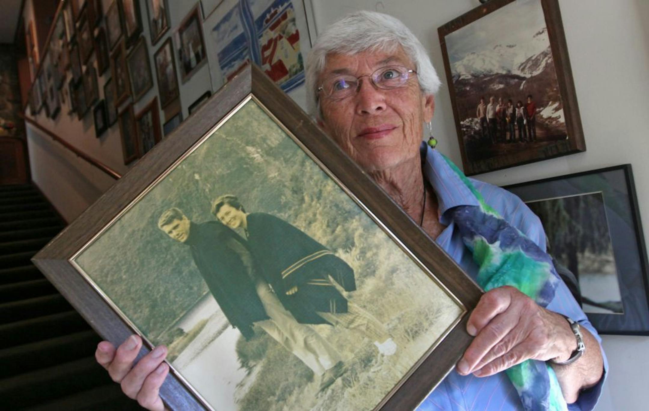 Rhoda Brooks held a photo of herself and her late husband, Earle, as she stood in her Excelsior home's hallway filled with photos and memories of their years together in the Peace Corps. The Peace Corps is celebrating it's 50th anniversary and the Brooks were there at the beginning in 1962.