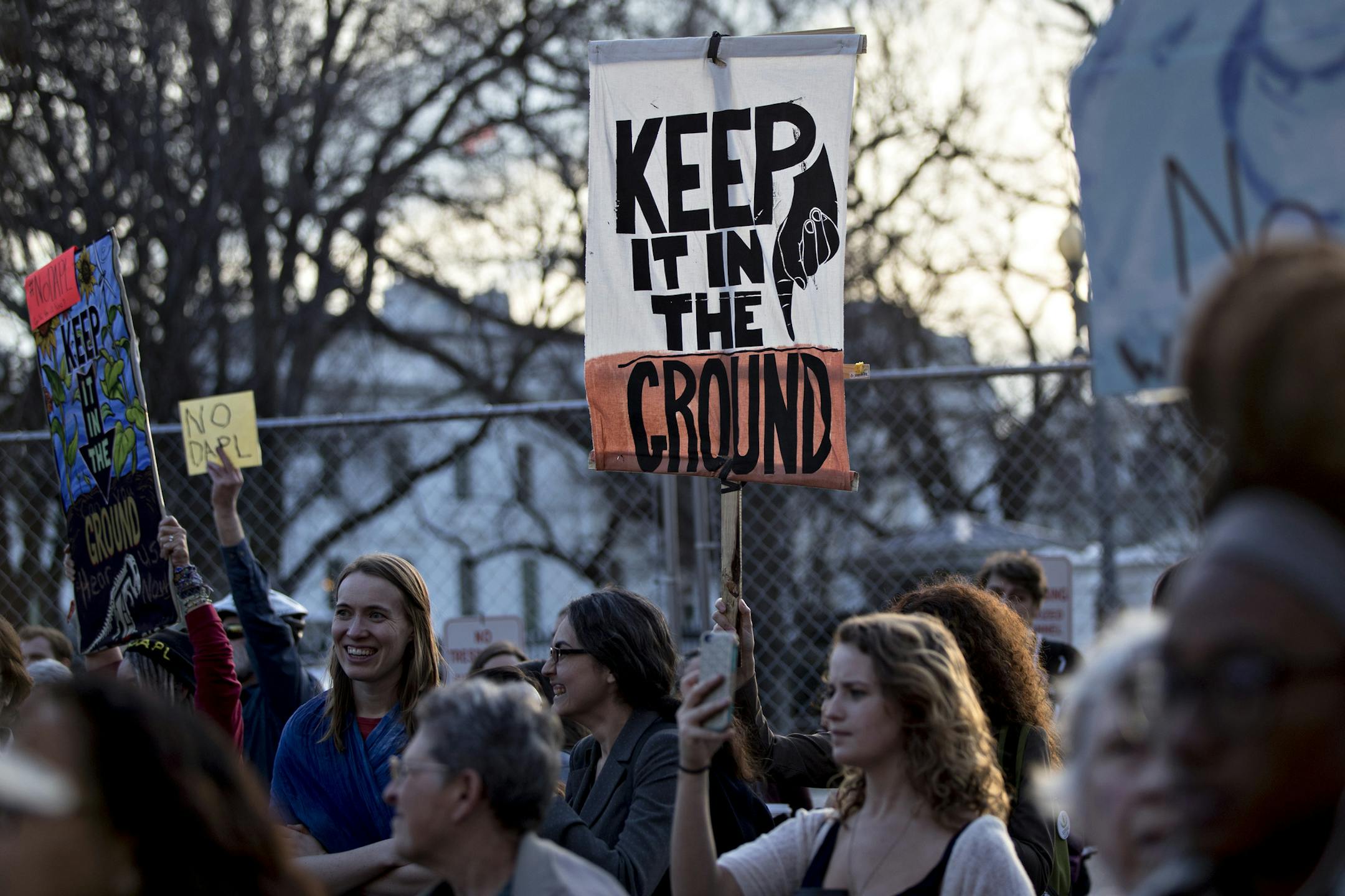 A demonstrator holds a sign during a protest against the building of the Dakota Access pipeline near the White House in Washington on Feb. 8, 2017. MUST CREDIT: Bloomberg photo by Andrew Harrer.