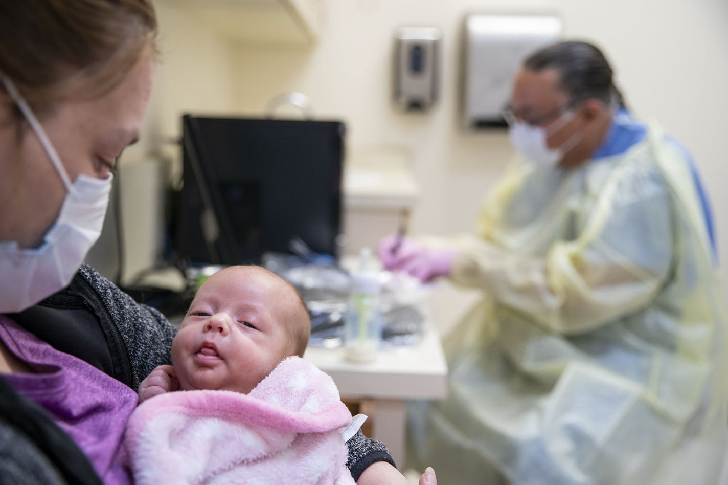 Cerri McKeon held her two-month-old daughter, Eden Smith while Dr. Vainio, MD took notes and he asked about her respiratory symptoms. Smith was tested for the flu, COVID-19 and RSV. The flu results came back negative and it will be a few days before the other results come back. ]
ALEX KORMANN &#x2022; alex.kormann@startribune.com The Min No Aya Win clinic on the Fond Du Lac reservation has seen a small amount of patients on a daily basis as they prepare for a wave of COVID-19 cases to hit their