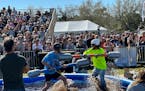 Competitors battled in a muddy pool with weapons made from pool noodles at the Florida Man Games on Saturday, Feb. 24, 2024, in St. Augustine, Fla.