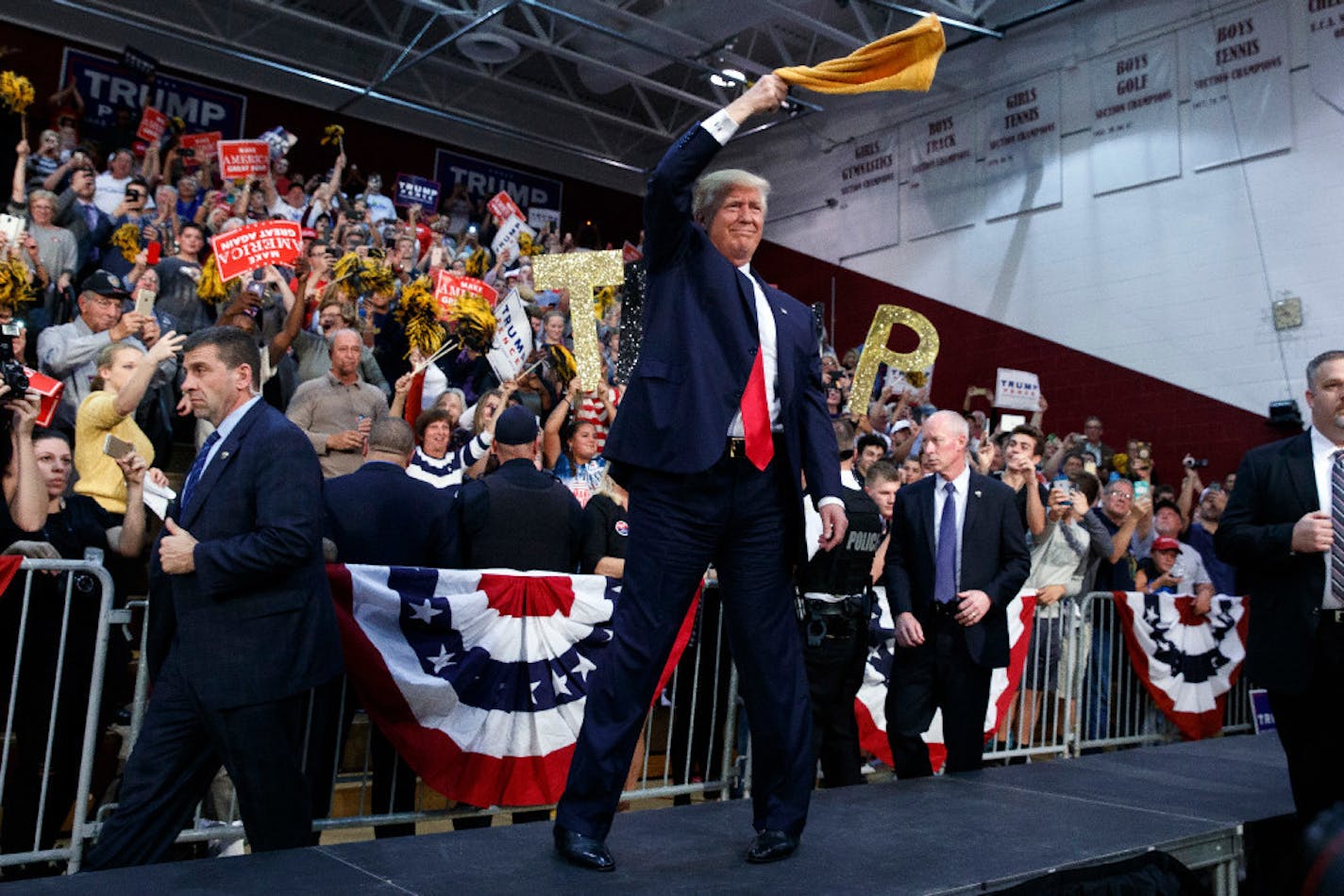 GOP presidential candidate Donald Trump waves a "Terrible Towel" as he arrives to speak at a campaign rally Monday in Ambridge, Pa.