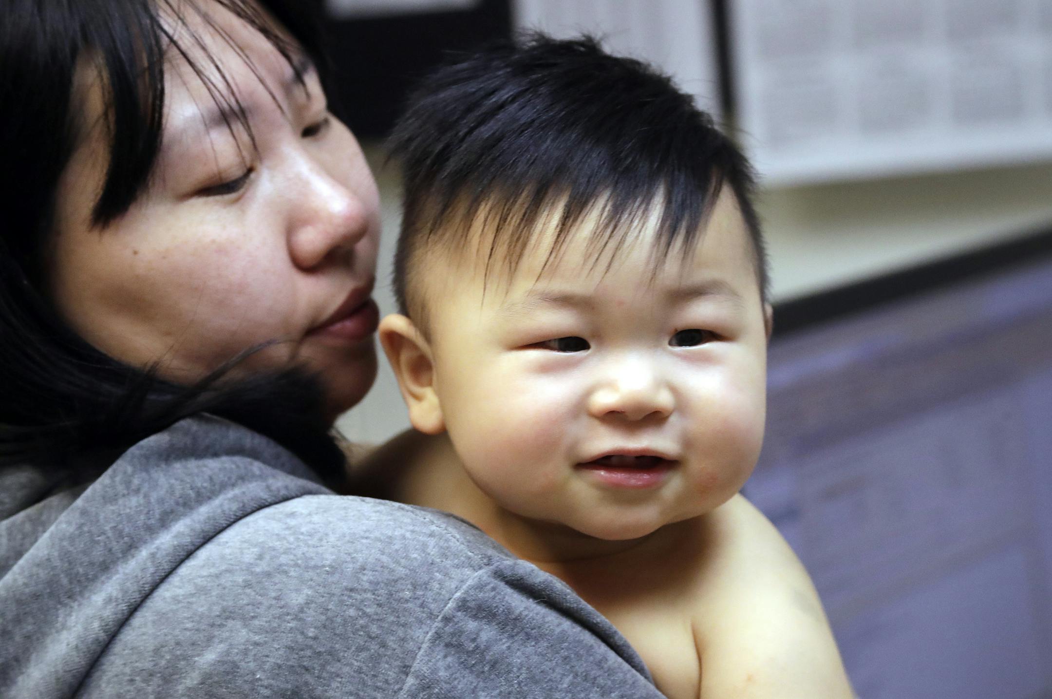 Able Zhang, 1, smiles after receiving the last of three inoculations, including a vaccine for measles, mumps, and rubella (MMR), as his mother Wenyi Zhang checks on him at the International Community Health Services Wednesday, Feb. 13, 2019, in Seattle. A recent measles outbreak has sickened dozens of people in the Pacific Northwest, most in Washington state and, of those, most are concentrated in Clark County, just north of Portland, Oregon. Washington Gov. Jay Inslee declared a state of emerge
