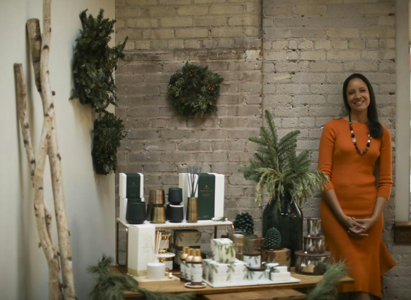 Thymes CEO Anne Sempowski Ward, photographed near a display of Frasier Fir products.