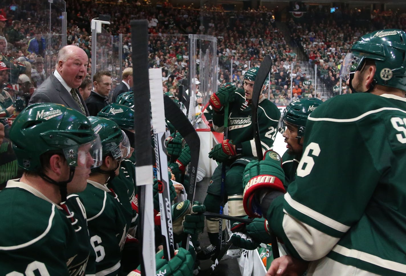 Minnesota Wild head coach Bruce Boudreau gives his players instructions during Saturday's home opener in St. Paul.