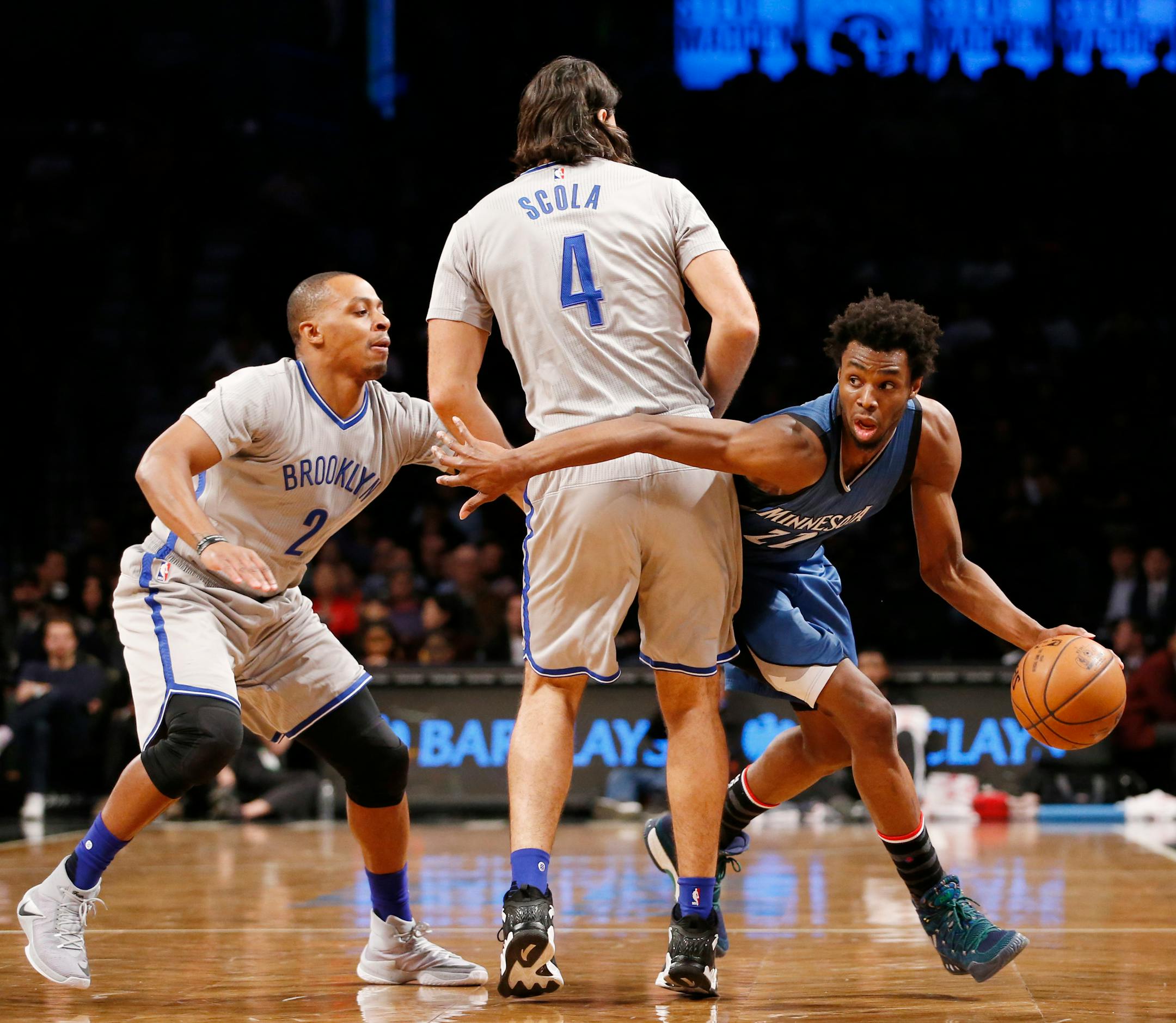 Timberwolves forward Andrew Wiggins looked to get past Nets forward Luis Scola (4) and guard Randy Foye during the first half of the Wolves' 119-110 loss to the Nets on Tuesday. Wiggins finished with 36 points.