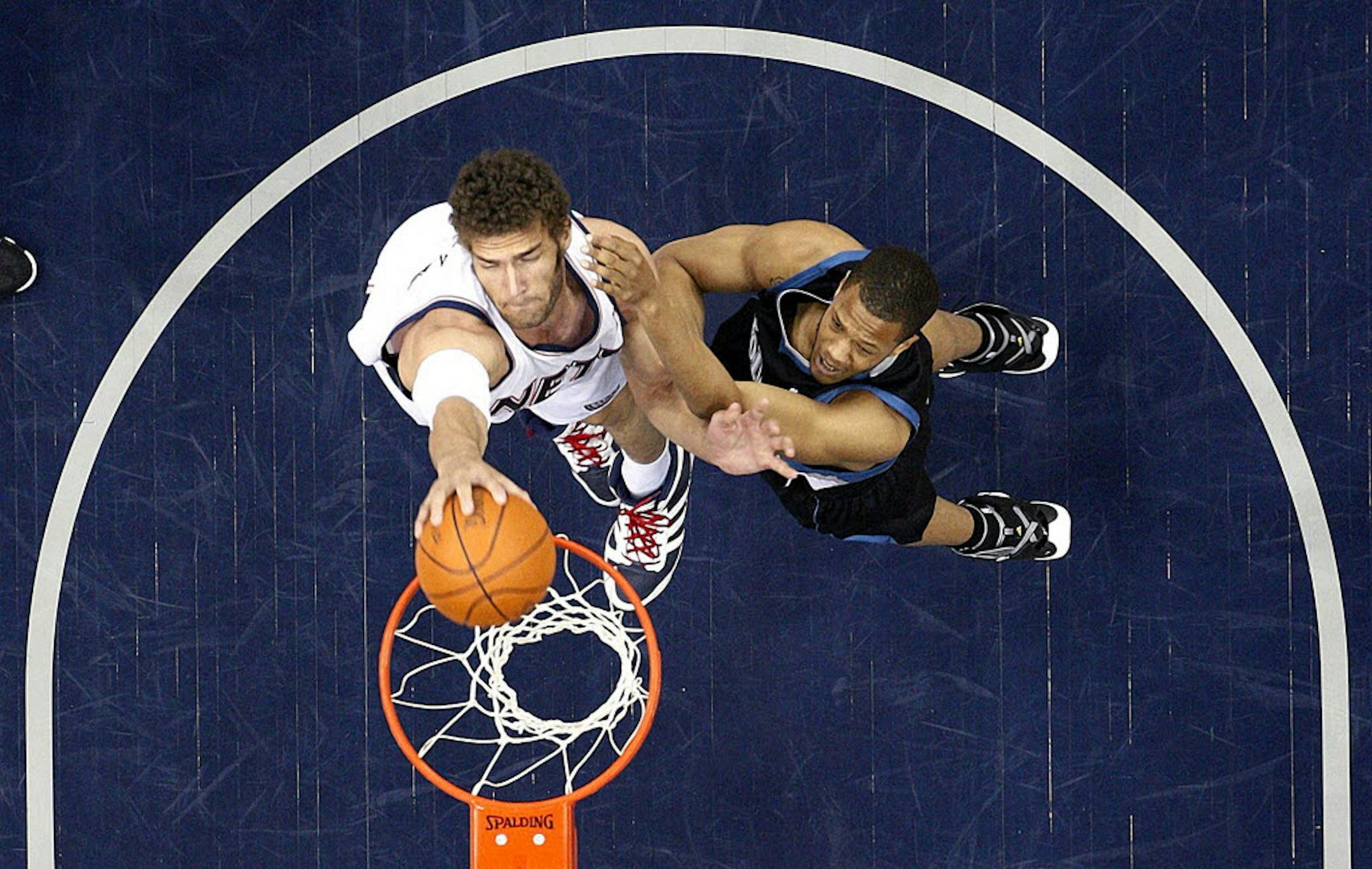 New Jersey's Brook Lopez (left), dunked against the Wolves' Anthony Randolph.