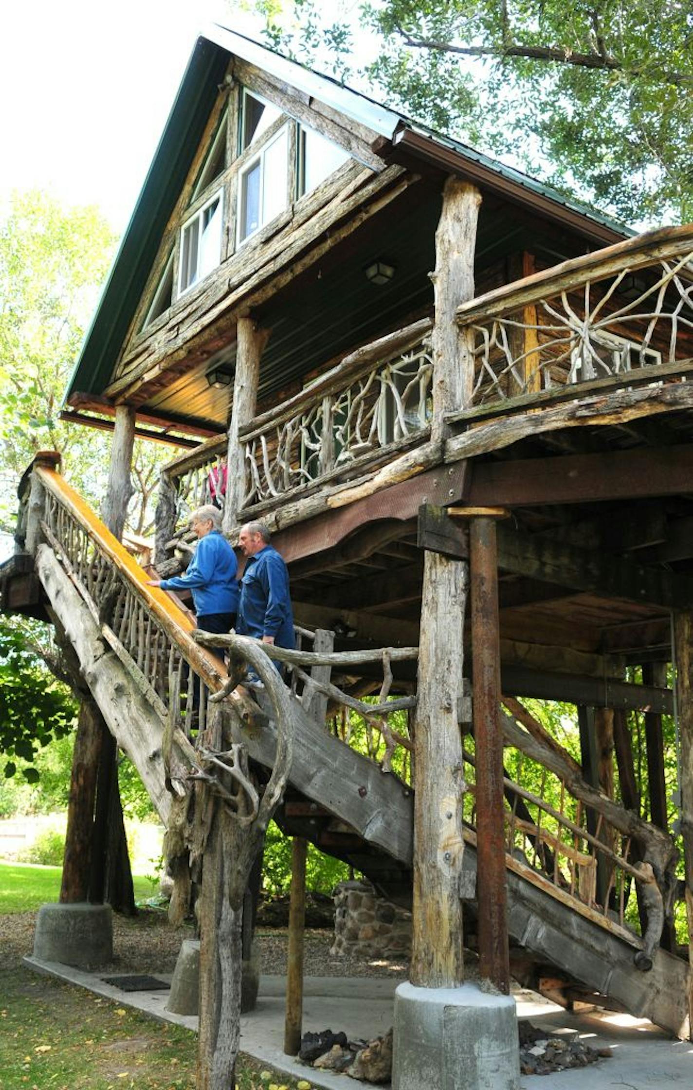 ADVANCE FOR WEEKEND EDITIONS SEPT. 24-25 - In this Wednesday, Sept. 14, 2011 photo, Will and Peggy Line walk up the steps to their treehouse on their property in Wadena, Minn. The 420-square- foot tree house is winterized and features all the comforts of home in the branches of the trees.