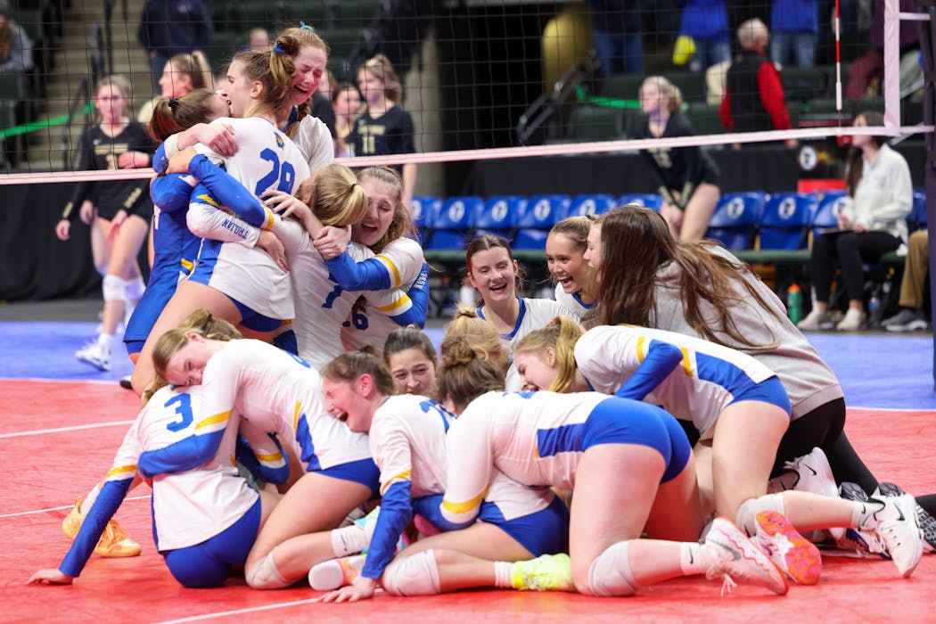 Wayzata volleyball players formed a happy heap after their volleyball state title was in hand in 2021.