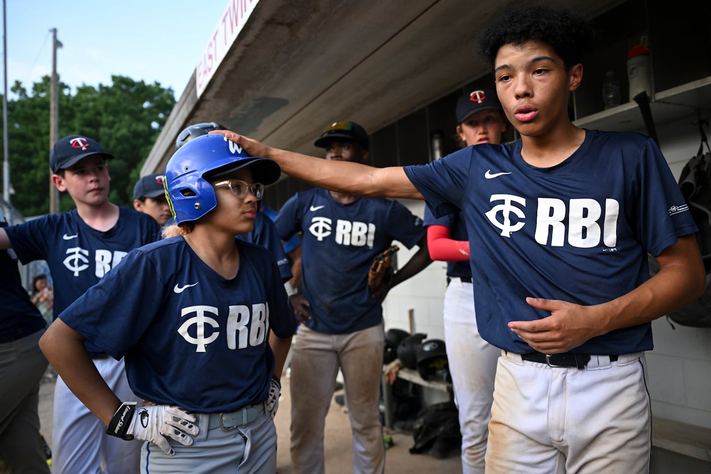 Keegan Erb, right, gives a pep talk to his team, including his sister, Kylee, during a U15 baseball game between the Midway Blazers and St. Agnes Thursday, June 22, 2023, at East Twins Babe Ruth Field in St. Paul, Minn. ] AARON LAVINSKY • aaron.lavinsky@startribune.com