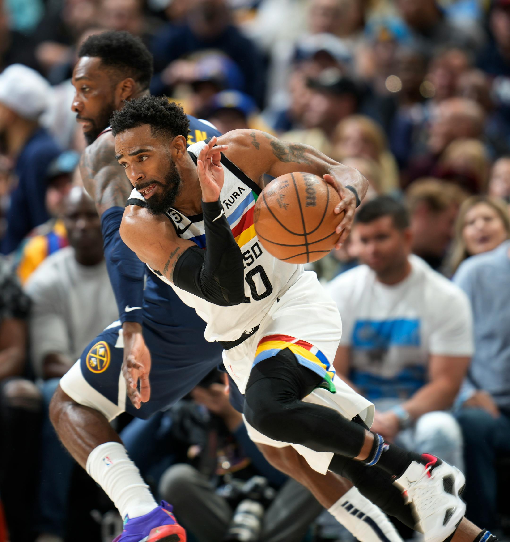 Minnesota Timberwolves guard Mike Conley, front, drives past Denver Nuggets forward Jeff Green during the second half.