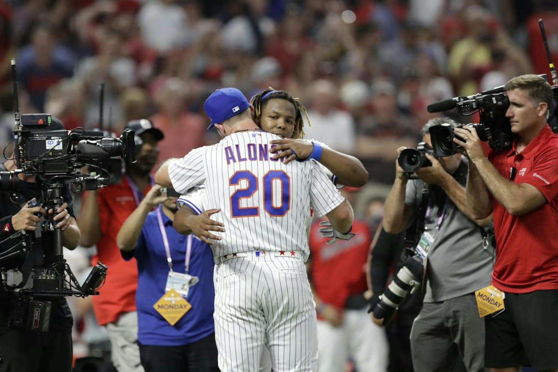 Vladimir Guerrero Jr., of the Toronto Blue Jays, congratulates Pete Alonso, of the New York Mets, after Alonso won the Major League Baseball Home Run Derby, Monday, July 8, 2019, in Cleveland. The MLB baseball All-Star Game will be played Tuesday.