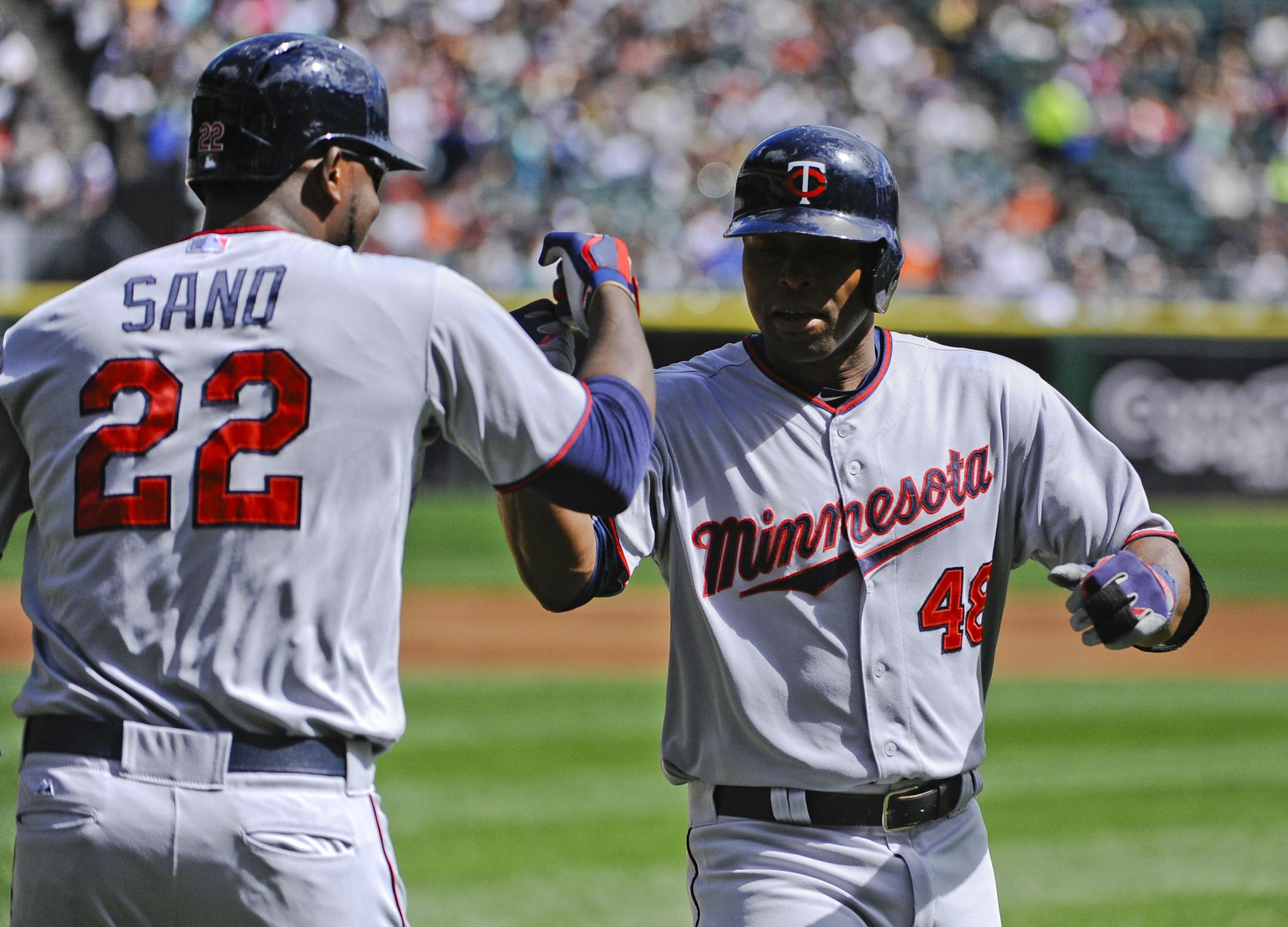 The Twins' Torii Hunter (48) high-fived designated hitter Miguel Sano after hitting a three-run home run in the first inning against the Chicago White Sox on Sunday.