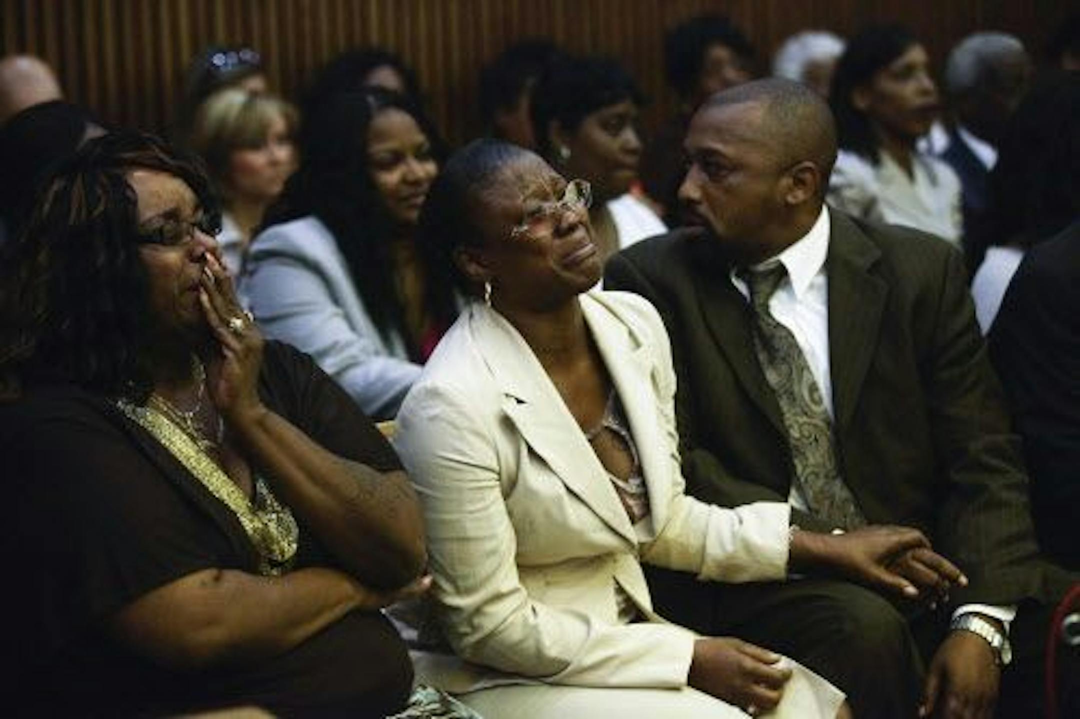 Monica McBride, center, and Walter Ray Simmons, right, parents of Renisha McBride, a woman shot and killed by Theodore Wafer after she banged on his doors in the middle of the night, react after a jury read the verdict during Wafer's murder trial in Detroit, Aug. 7, 2014.