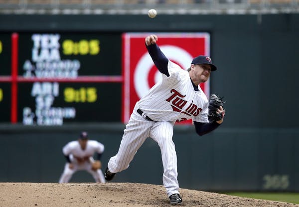 The Minnesota Twins' Kevin Correia pitches in the sixth inning against the Miami Marlins in the first game of a doubleheader at Target Field on Tuesda