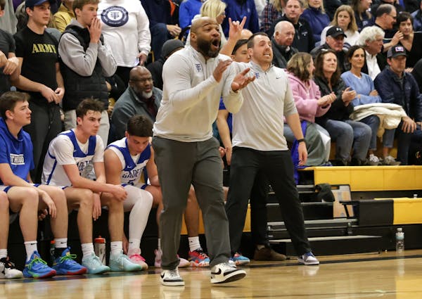 Khalid El-Amin, shown coaching during a high school basketball game in March 2023, is set to get a $15,000 settlement from the city of Minneapolis in 