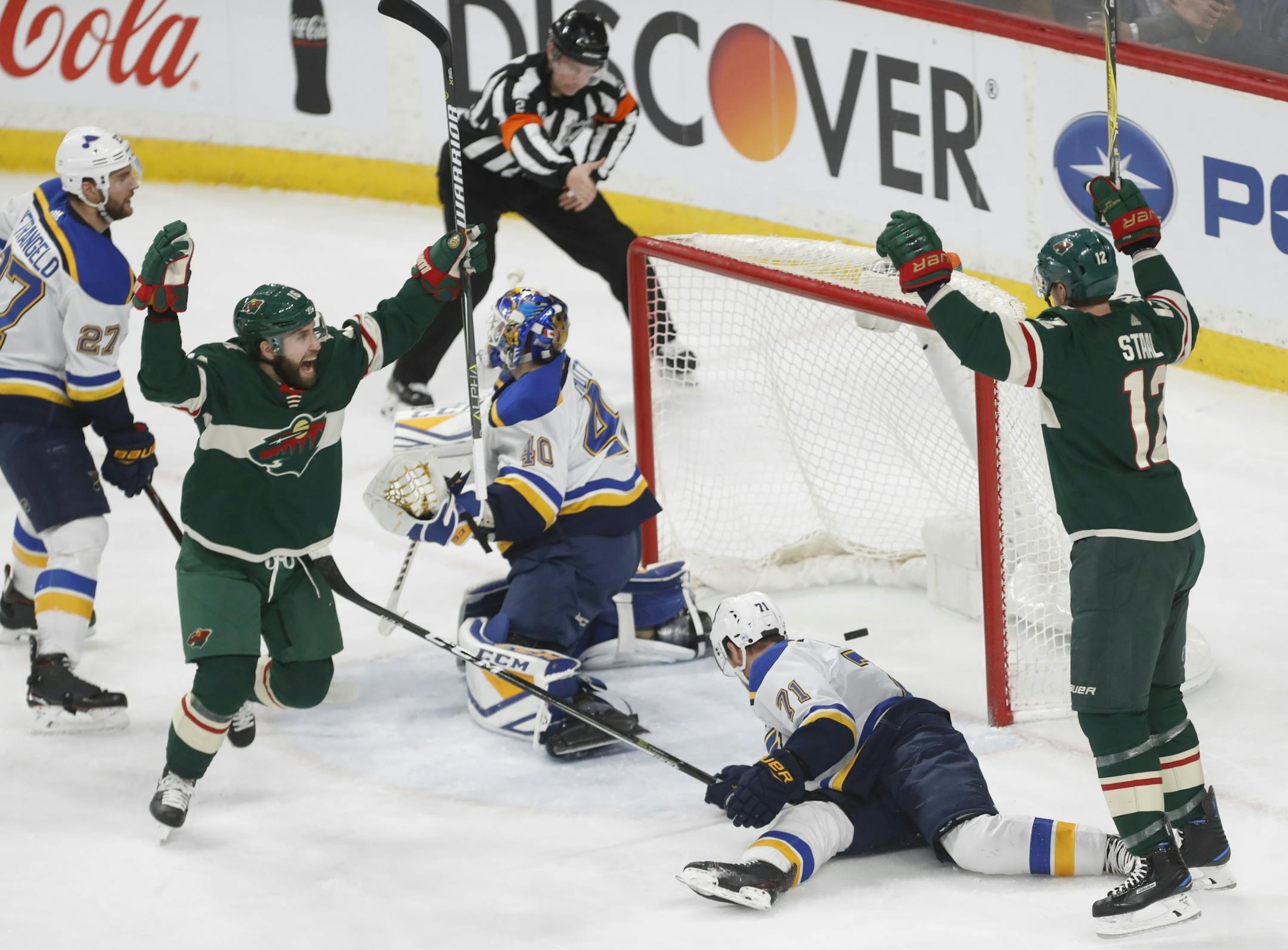 Jason Zucker(16) and Eric Staal(12) celebrate the Wild's fourth goal.