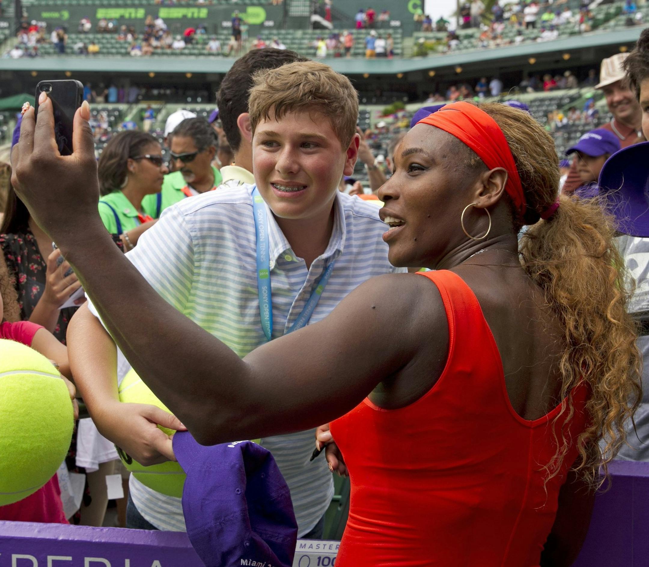 Serena Williams shoots a "selfie" with fans after winning her seventh Sony Open title, defeating Li Na, 7-5, 6-1, on Saturday, March 29, 2014, in Key Biscayne, Fla. (Al Diaz/Miami Herald/MCT) ORG XMIT: 1151021