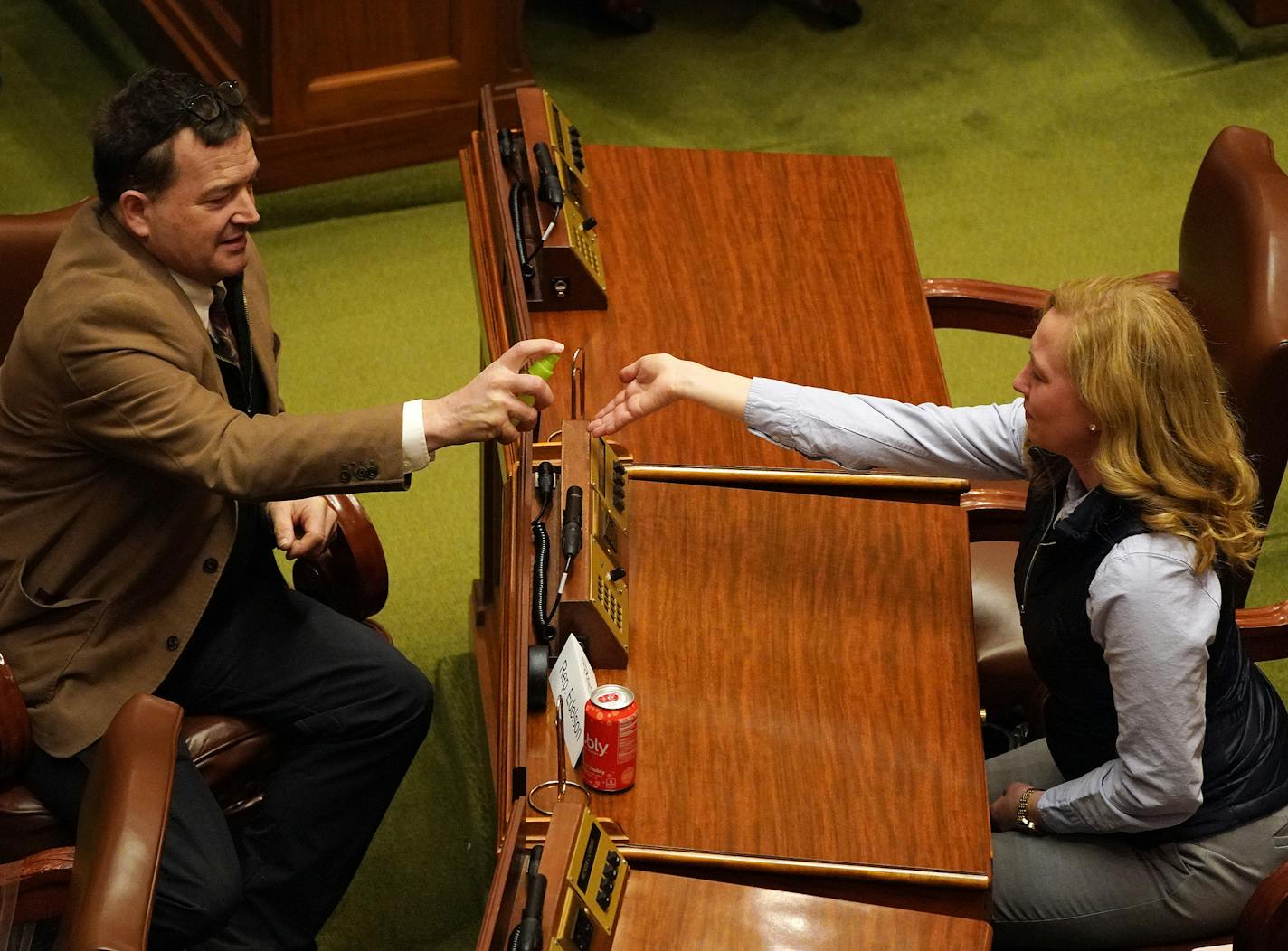 Rep. Leon Lillie, DFL-North St. Paul, gave a sprits of hand sanitizer to Rep. Heather Edelson, DFL-Edina, as the Minnesota House convened to pass COVID relief legislation amid the Coronavirus pandemic Thursday. ] ANTHONY SOUFFLE &#x2022; anthony.souffle@startribune.com The Minnesota House convened to pass COVID relief legislation amid the Coronavirus pandemic Thursday, March 26, 2020 at the Minnesota State Capitol Building in St. Paul, Minn.